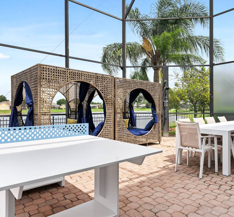 Private patio with outdoor dining and pool enclosure at Formosa Gardens vacation home