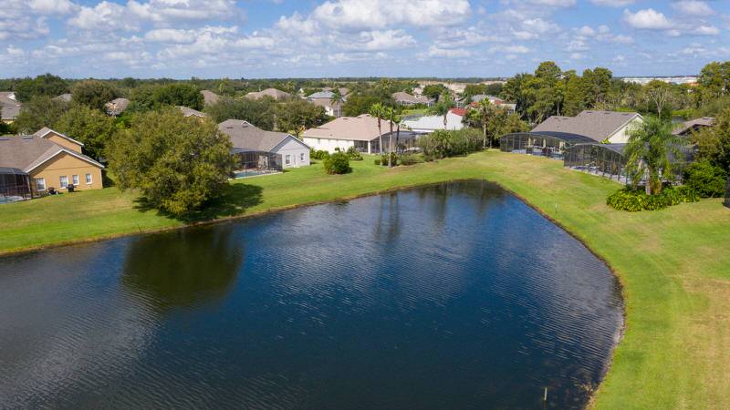erial view of Formosa Gardens Orlando neighborhood with luxury vacation homes, private pools, and scenic lake views near Disney